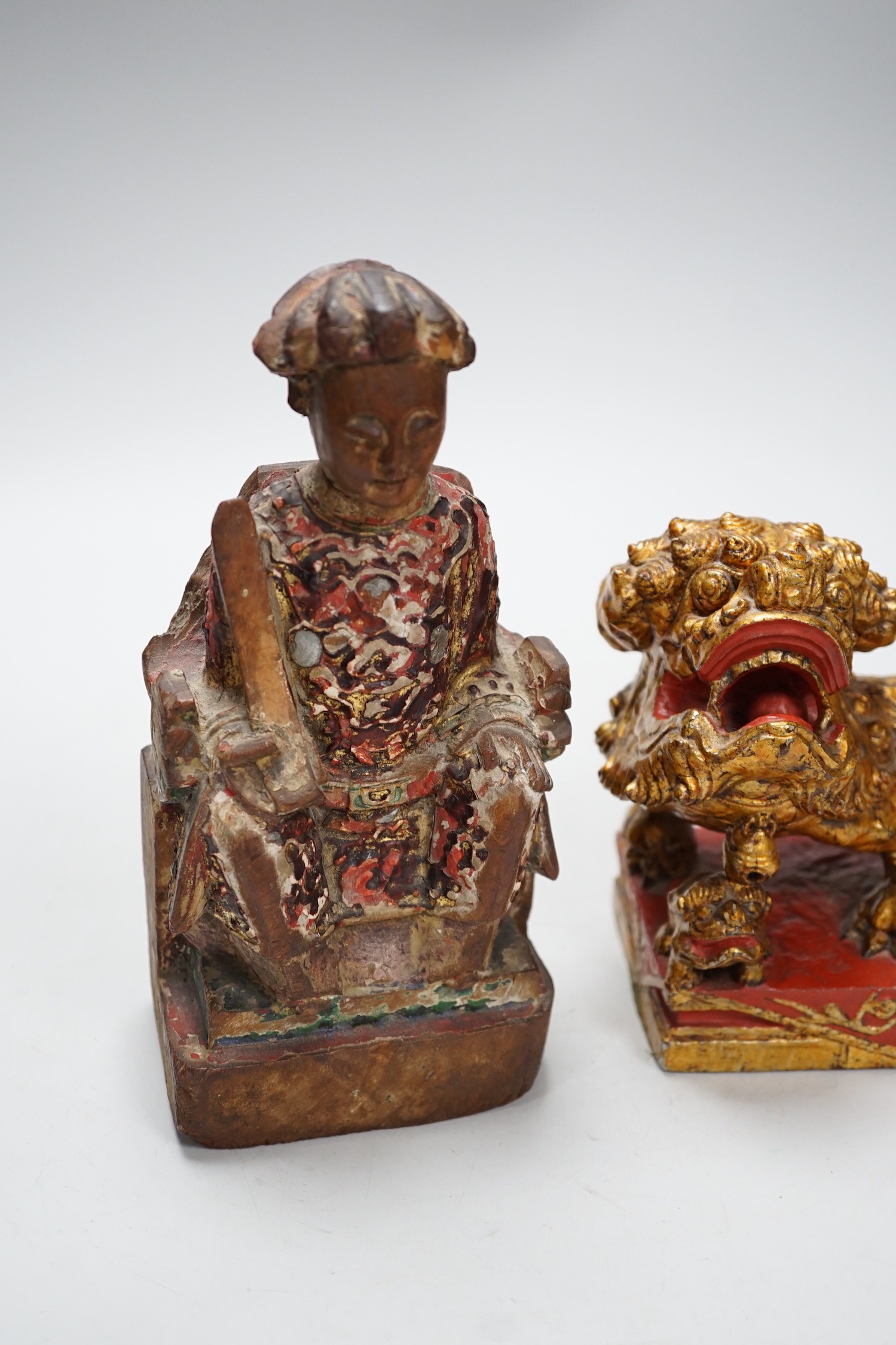 A Chinese lacquered wood figure of a seated woman and a Buddhist lion, tallest 20.5cm